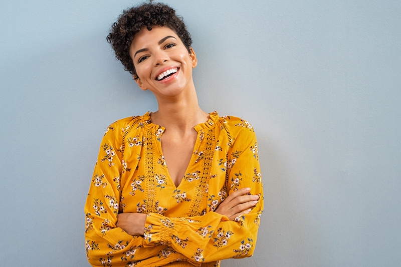 Cheerful african woman smiling eyelid lift