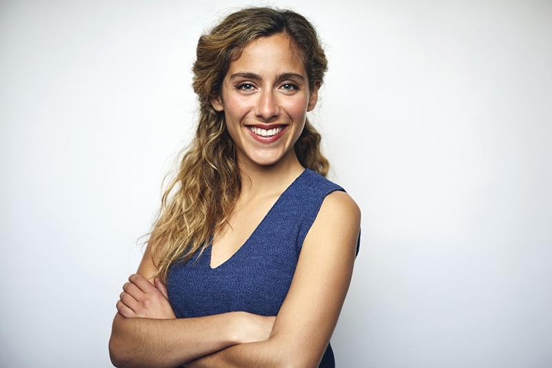 Businesswoman with arms crossed over white eyelid lift